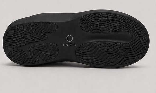 Outsole view of the black Inyo Mule showing the wave-pattern tread.
